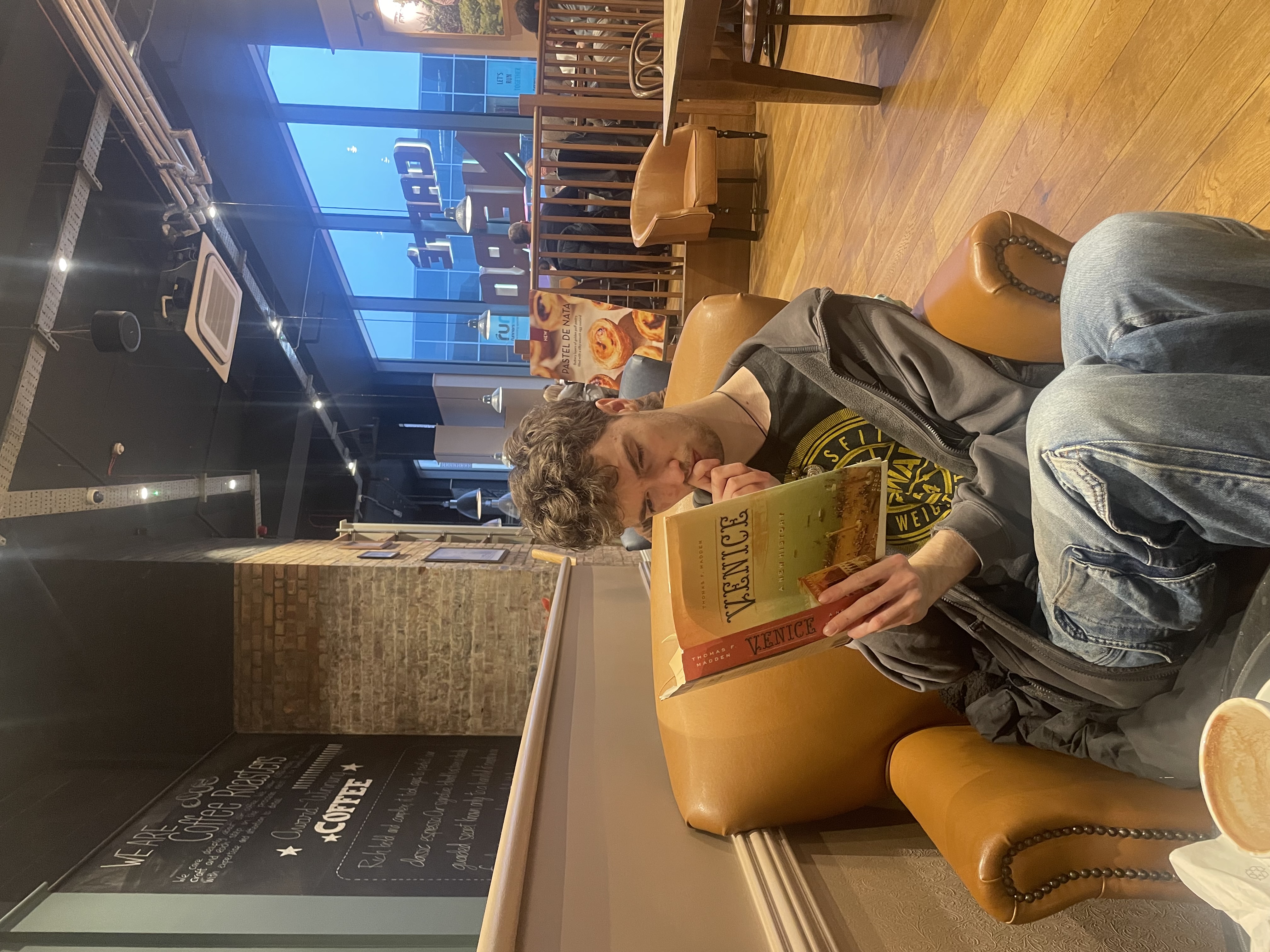 James Wheelr reads a book titled Venice after winning the Venice Biennale Fellowship